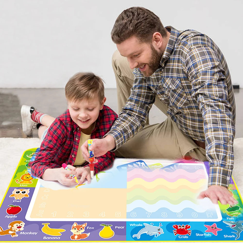 Child drawing on the water mat with a water pen