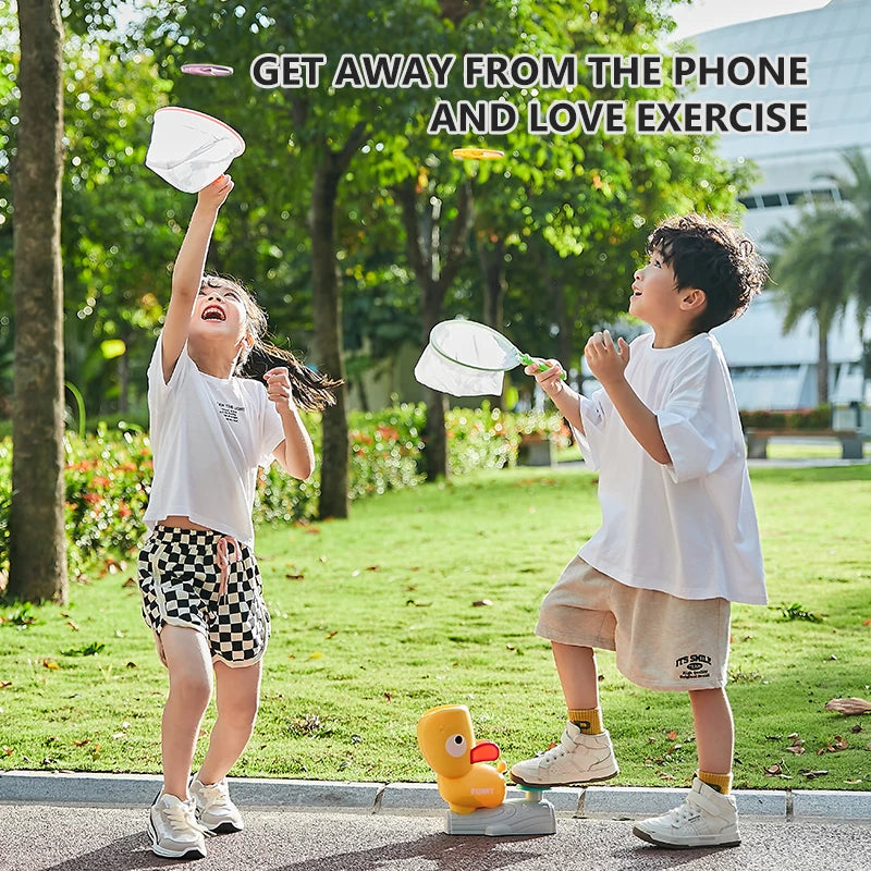 Child chasing and catching a flying disc with the net