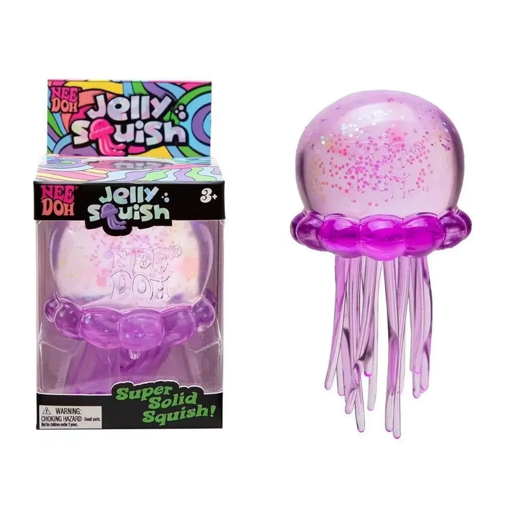 Jellyfish squish ball sitting on a desk beside a keyboard