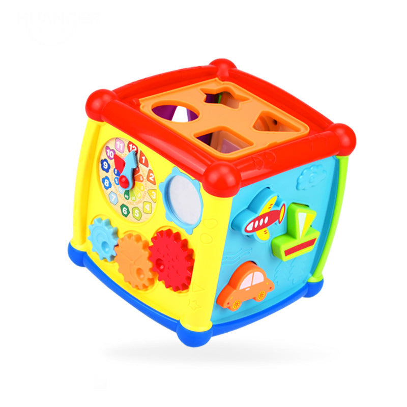 Activity cube shown next to a baby for size reference