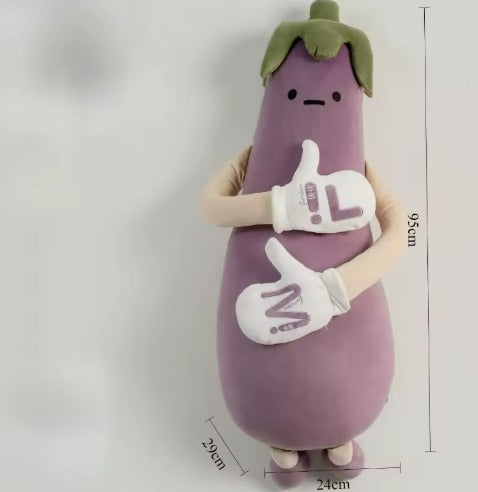 Sir Eggplant plush sitting on a bed as a quirky room accent